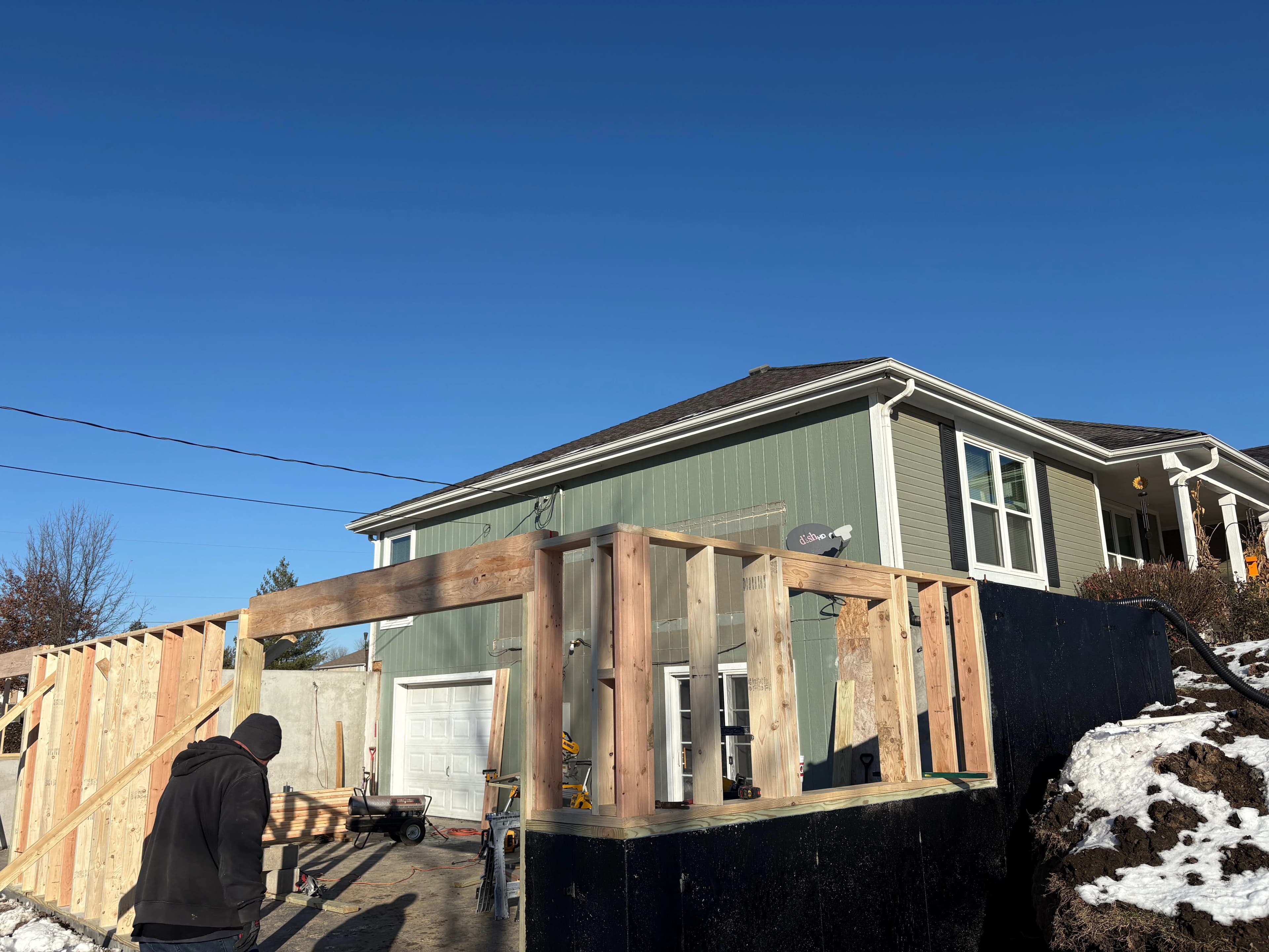Addition framing work documented on site.